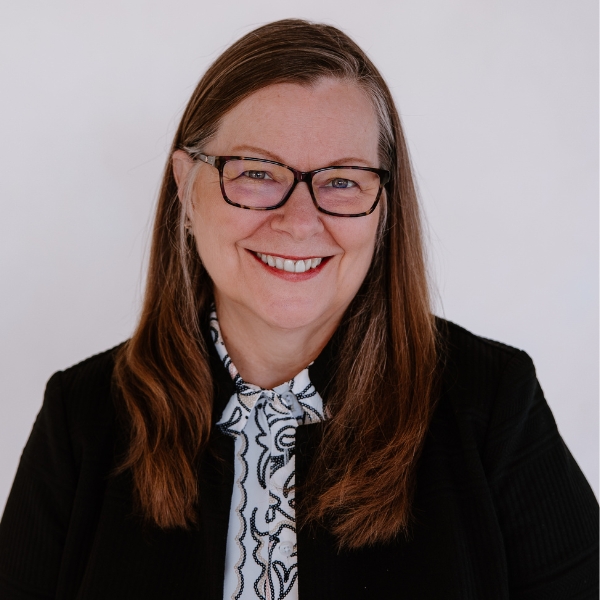 2026 Conference Headshots Resized White background headshot of female with glasses